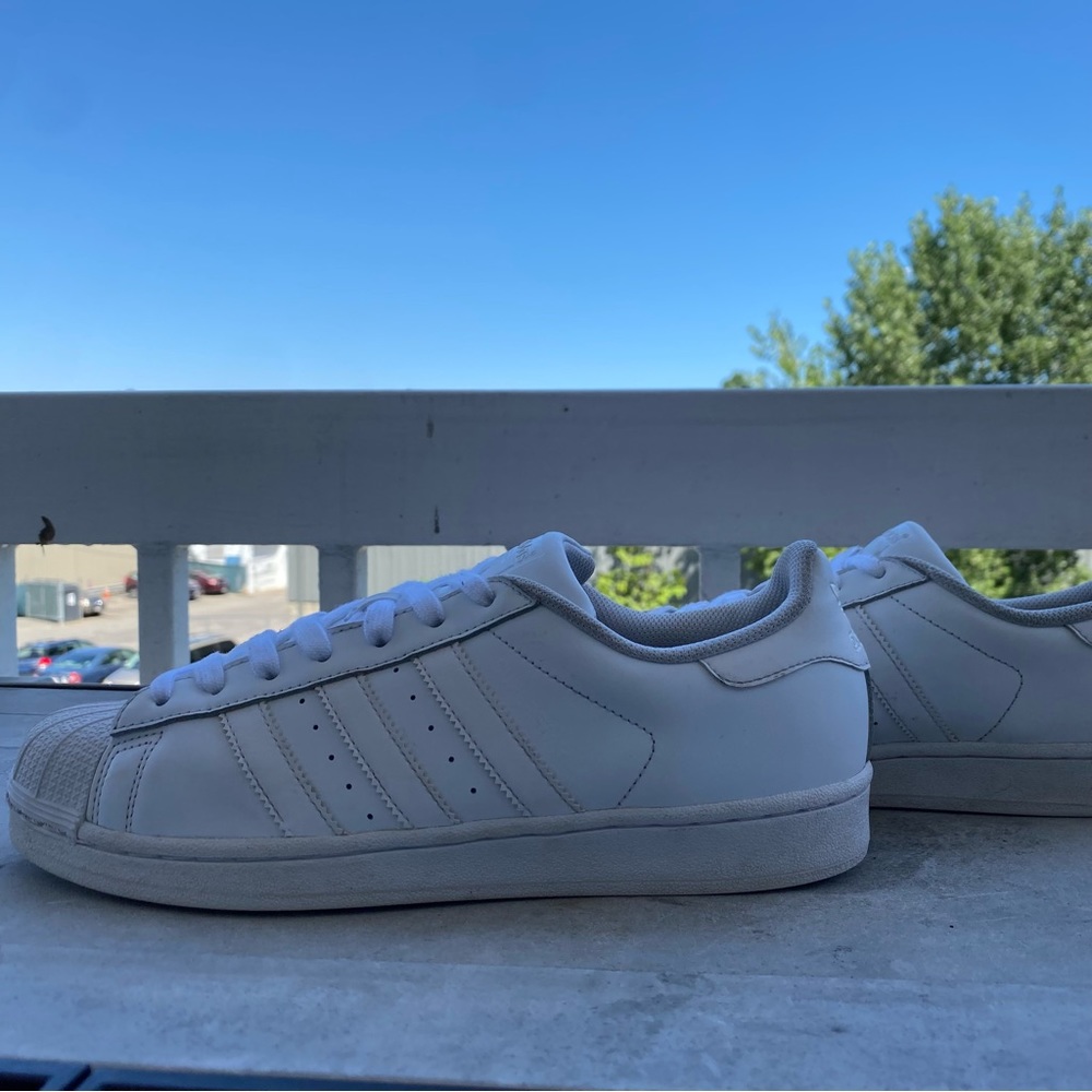 All white Adidas Superstars